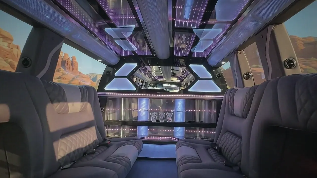 Inside the Cadillac Escalade limo in Keystone: LED light-show ceiling, leather lounge seating and lit bar